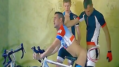 Cycling riders in red jerseys are fucking in the bicycle