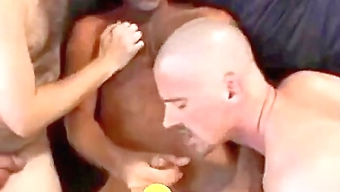 Two tattooed men fucking one girl in two hands and in mouth