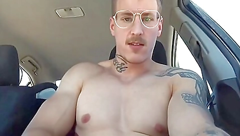 Tattooed man sticks hands into a tattooed babe in the car
