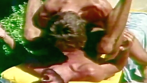 Vintage brunette 18+ is on the beach sucking on his cock