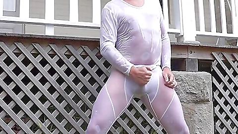 Beautiful brunette with wet lycra spreads legs outdoors